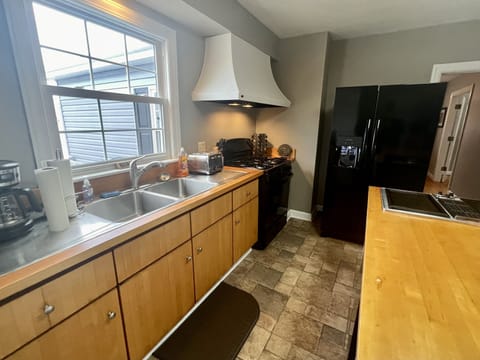 Side by side refrigerator with ice maker and gas stove in the kitchen