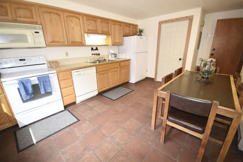 Kitchen with dining table to seat 6, plus two additional chairs in closet
