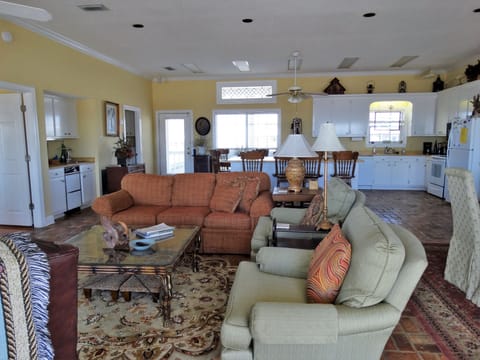 Entering the house to the left is the living room and beyond is a large kitchen.
