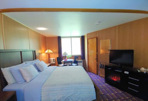 room view from the entry; fire place , king bed, operable window