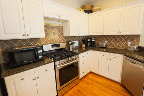 The kitchen features brand new stainless steel appliances.