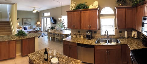 Modern Gourmet Kitchen Open & Inclusive with Main Room- Features Bartop Seating