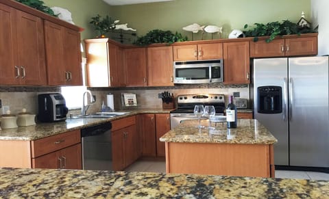 Stainless Steel, Granite, Stone Tile, Wood Cabinets.