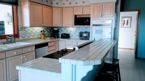 Kitchen connected to breakfast nook, laundry-room, formal dinning and living-room