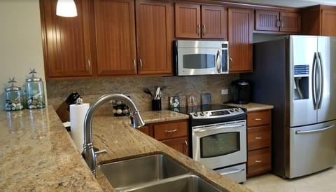 Stainless steel kitchen appliances. Fully appointed kitchen.