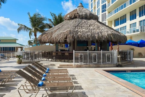 Ample pool seating, and tiki bar