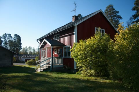 The main house and veranda with views through the garden and down to the lake.
