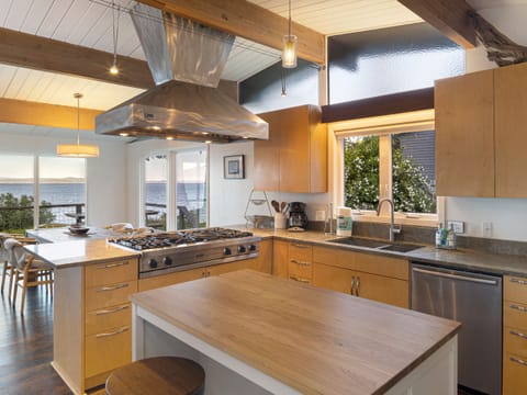 Open, modern kitchen with Viking Professional appliances and All-Clad cookware.