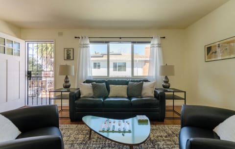 Large, bright living room with leather couch