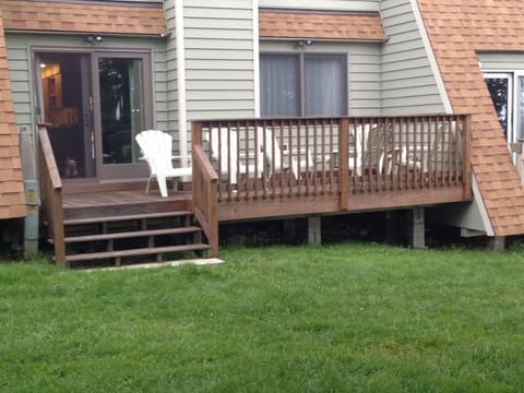 Back deck with level yard for games (cornhole boards and bags in unit)