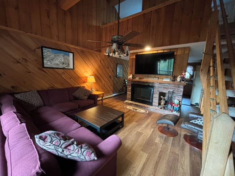 Large open family room with sectional couch and recliner.  