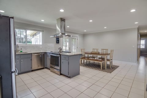 Updated Dining Room & Kitchen w/ stainless fridge, oven, and range hood.
