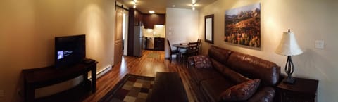 Panorama of living room, dining table in corner and kitchen in the back..all new