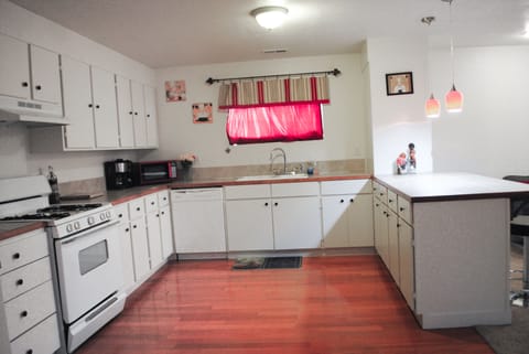 Full kitchen with pots, pans, plates, cups, silverware, coffee maker, microwave.
