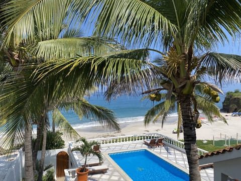 Pool and beach viewed from one of Casa Serena's bedroom