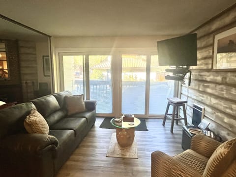 Living room looks out sliders on two parking spaces for D5.