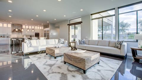 Large comfy couches in the TV room w/ natural lighting off the kitchen 