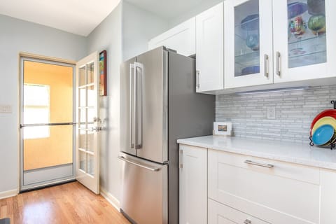 Covered private washer and dryer is just outside the kitchen door