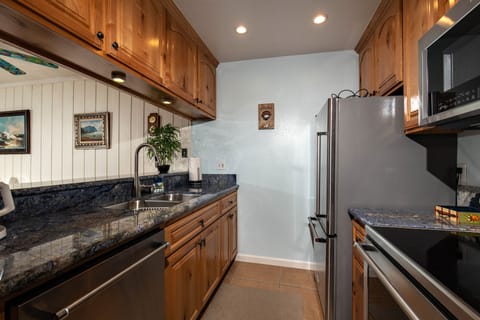 The kitchen is equipped with dishes, pots and pans, and serving pieces for the chef in your party.