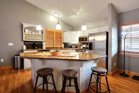 Gourmet Kitchen with Breakfast Bar and Granite Counter-tops
