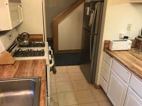 Kitchen with Gas Stove, Large Sink, Microwave, and Oven.  
