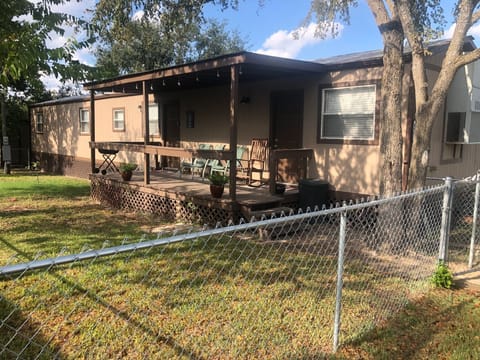 Fenced yard with large covered front porch. 