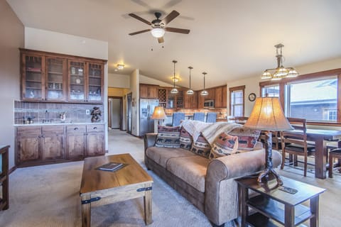 Living Area - Spacious area with wet bar, queen size sofa sleeper, and flat screen TV.