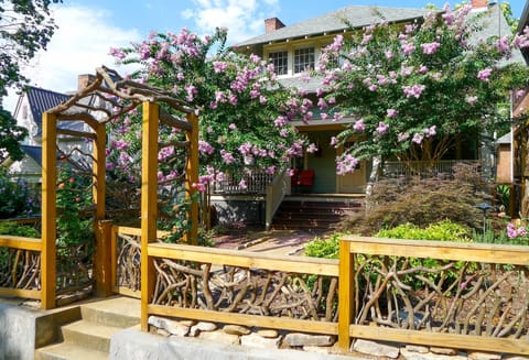 View of the Cozy Cottage in Spring with artfully designed Mountain Laurel Fence.