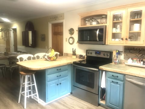 Fully stocked kitchen for cooking meals at home.  Bar seats 4