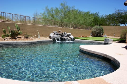 Private backyard with pool and putting green