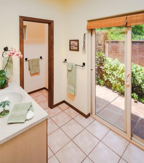 Bath offers a slider to the sunny outdoor shower.