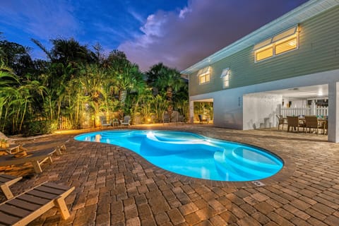 As dusk settles in, the glow from the pool lights ripples across the water—this is the kind of evening you'll remember.
