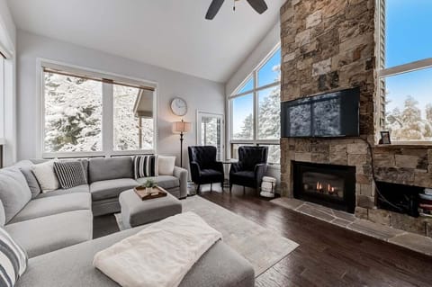 Great room features vaulted ceilings, gas fireplace, and large smart tv.  