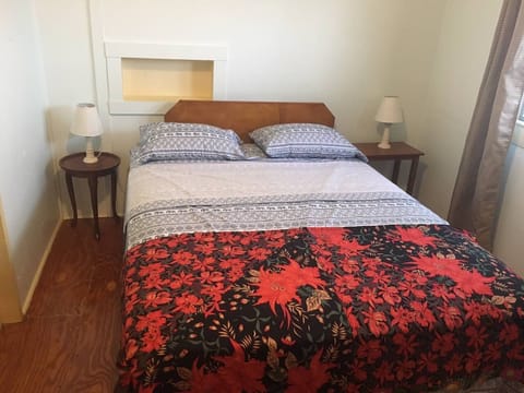 Queen size bed, air conditioning, and lots of light make this room bright.