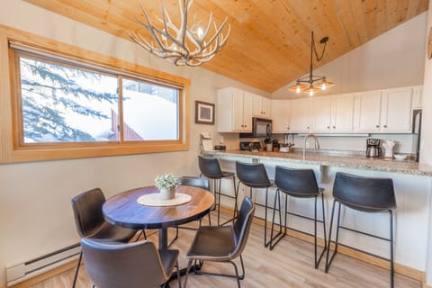 Breakfast bar with seating for four and dining area with seating for four
