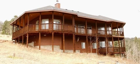 This is the view from the other side of the house, where you can see the porch. Take note of the private deck on the lower level; this has a private entrance form the downstairs master bedroom. 