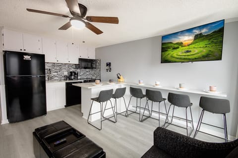 Discover Mountain Lodge 235! This fully renovated property boasts a modern kitchen with sleek black appliances and a dining area that comfortably seats six.