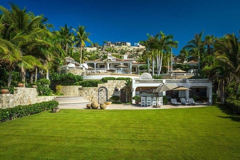 Large oceanfront lawn and the main house at Casa Edwards, beachfront luxury villa in Palmilla, Los Cabos