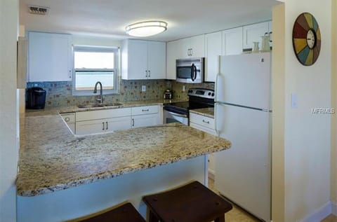 open concept updated kitchen with Stainless Steel appliances, granite countertop