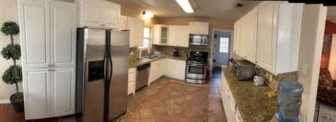Large open kitchen fully stocked for your cooking needs.
