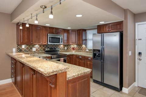 Your vacation starts with this gorgeous kitchen boasting cherry cabinetry.