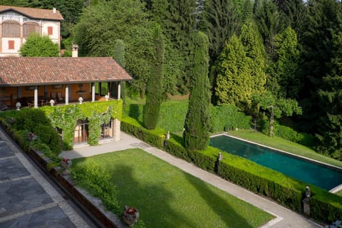 View of the pool, outdoor dining portico, garden and terrace from bedroom 1