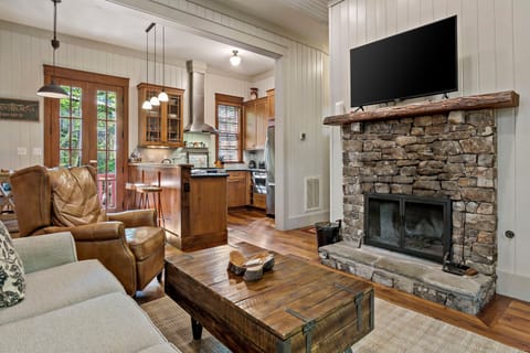 Main-level living room with a wood-burning fireplace, and flat-screen TV with streaming options.
