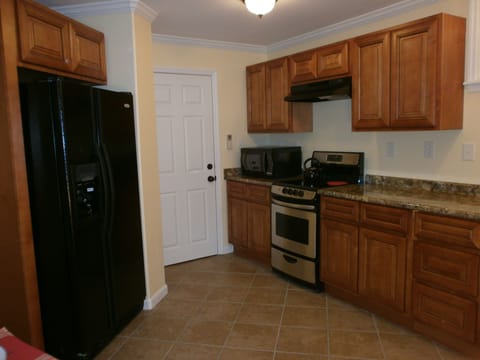Entry way into kitchen. Full size refrigerator with icemaker.