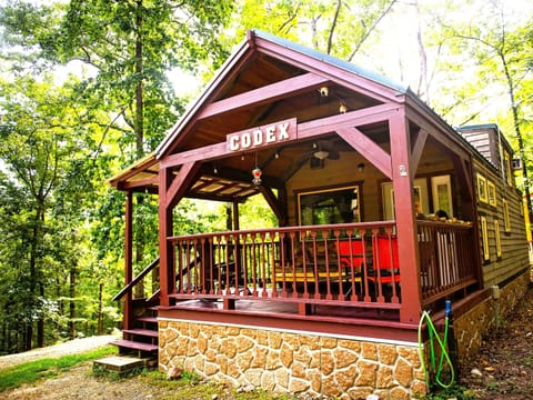 Cozy cabin retreat with forest views and a welcoming covered deck - private woodland escape ideal for peaceful getaways - rustic outdoor living perfect for relaxing in nature.