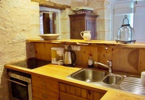 Kitchen with cooker, oven, sink, water cooker, coffee machine, fridge & freezer