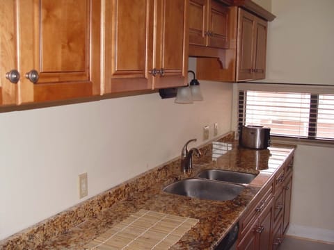 Fully equipped kitchen with granite countertops.