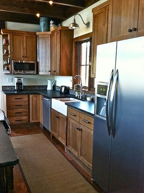 Custom cabinetry, granite counters, stainless appliances and a farmhouse sink.