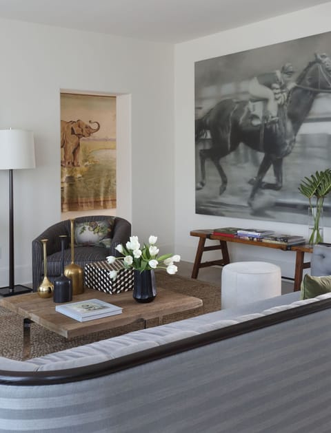 Large living area with seating for 6-8. Original art and large screen smart TV