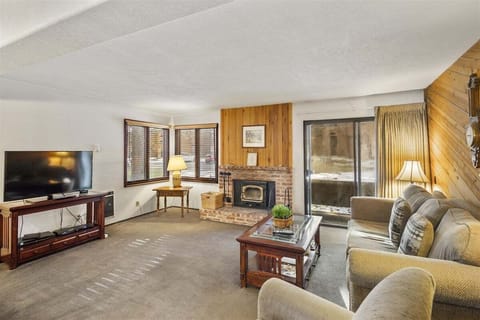 Living room with wood burning stove, and access to the deck